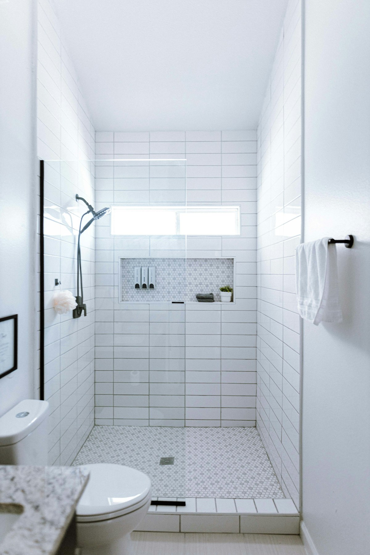 Bright tiled shower with contrasting dark fittings, shown as design inspiration